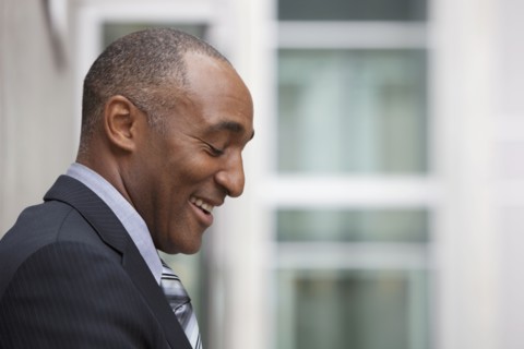 Mixed race businessman laughing