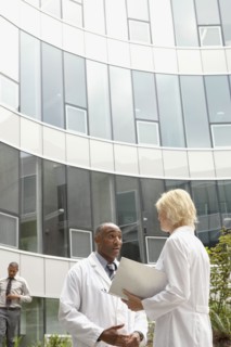 Doctors talking in hospital courtyard