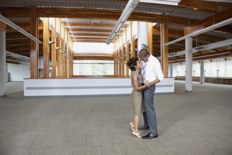 Couple dancing in empty office space