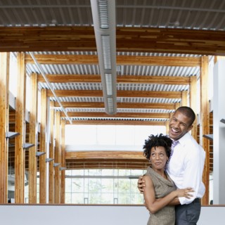 Couple laughing in empty office space