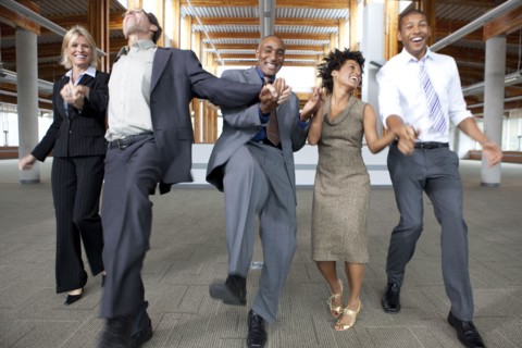 Business people dancing in empty office space