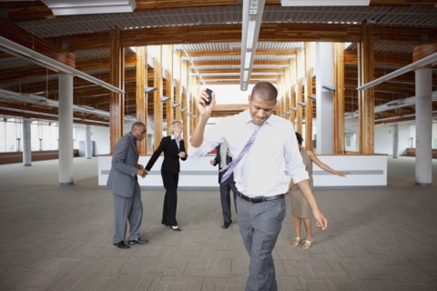 Business people dancing in empty office space