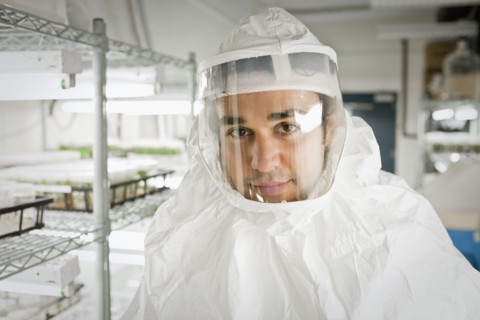 Middle Eastern scientist in clean suit in laboratory