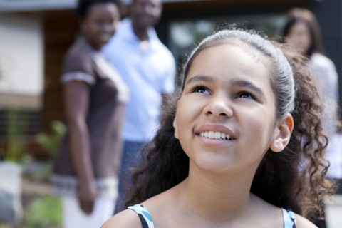 Smiling mixed race girl looking up