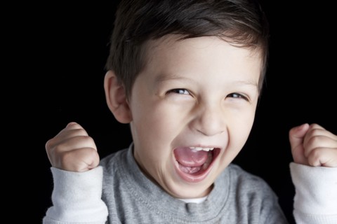 Close up of Hispanic boy cheering