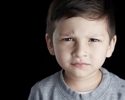 Close up of Hispanic boy frowning