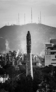 Statue on pillar in cityscape