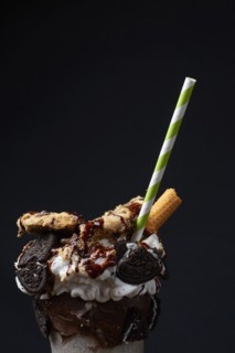 Straw in ice cream sundae with cookies