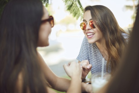 Smiling Hispanic women wearing sunglasses