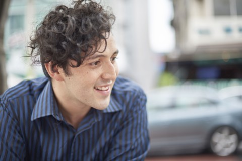 Smiling Hispanic man with curly hair