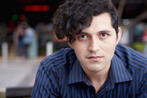 Serious Hispanic man with curly hair