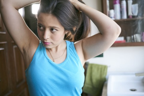 Hispanic woman lifting hair