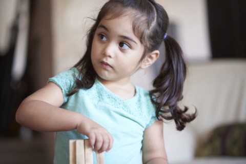 Curious Hispanic girl looking away