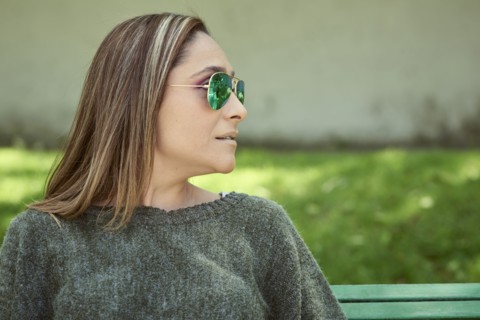 Hispanic woman wearing sunglasses