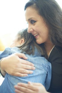 Hispanic mother hugging daughter