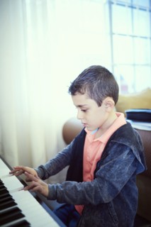 Hispanic boy playing piano