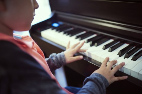 Hispanic boy playing piano