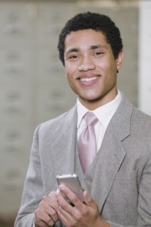 Mixed race businessman holding cell phone