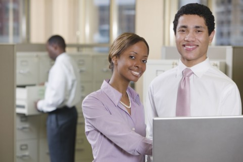 Multi-ethnic business people working on laptop in office