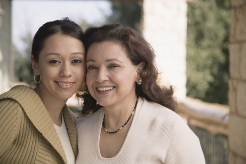 Multi-ethnic mother and daughter smiling