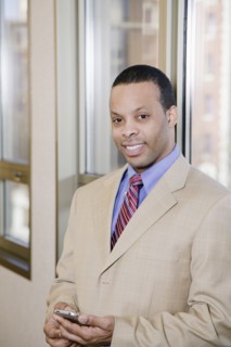African businessman holding cell phone