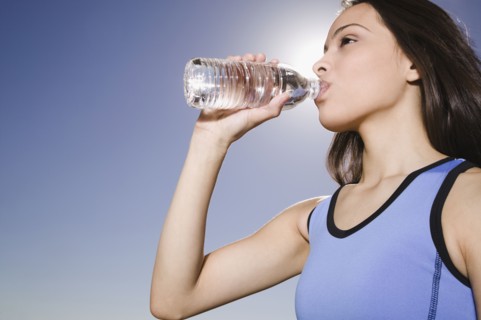 Thirsty Hispanic woman drinking water