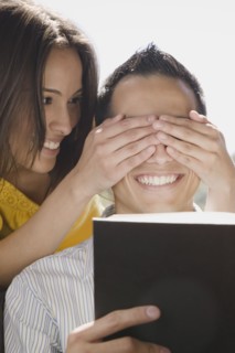 Girlfriend covering boyfriend's eyes