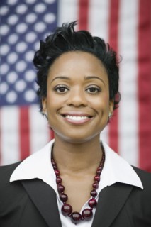 African businesswoman standing near American flag