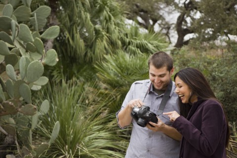 Couple looking at pictures on digital camera