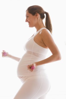 Pregnant woman lifting weights