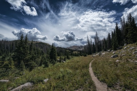 Clouds over trail in rocky landscape