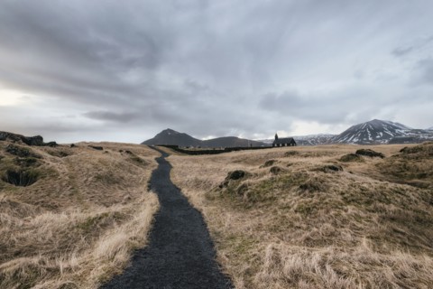 Dirt road to distant church