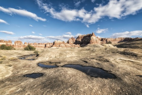 Clouds in blue sky over desert in Moab
