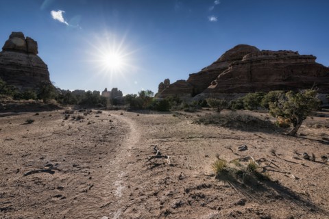 Sun in blue sky over desert