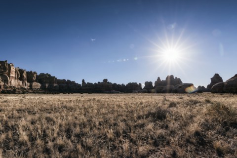 Sun in blue sky over desert