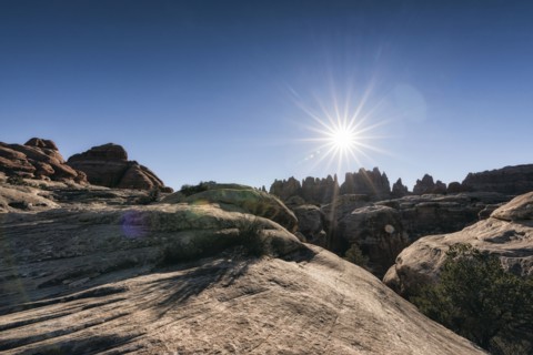 Sun in blue sky over desert