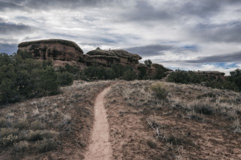 Clouds over desert path