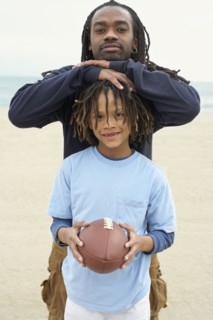 African father and son with football