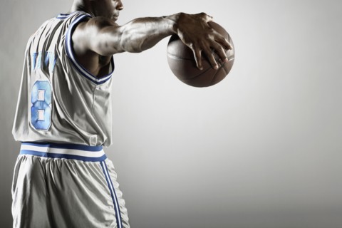 African basketball player holding basketball