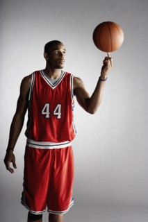African basketball player spinning basketball