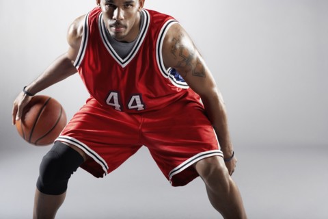 African basketball player bounding basketball