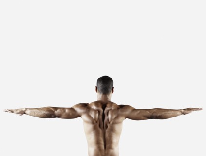 Bare chested mixed race man with arms outstretched