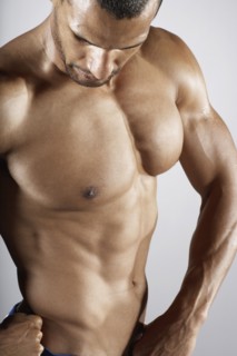 Bare chested mixed race man