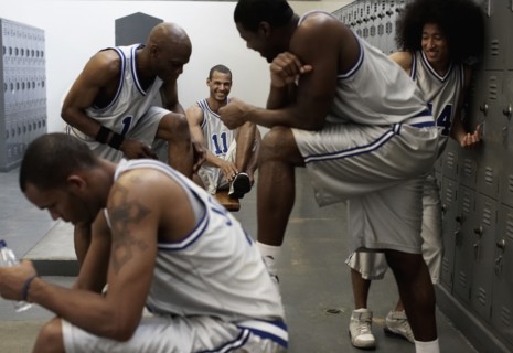 Multi-ethnic basketball players dressing in locker room