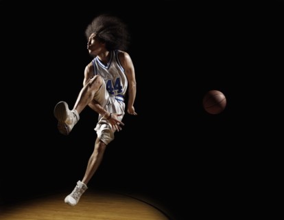 Mixed race basketball player passing basketball