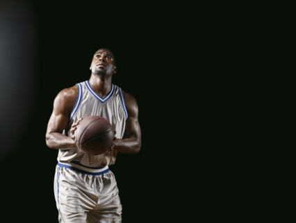 African basketball player holding basketball