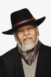 Close up studio shot of senior African man wearing hat