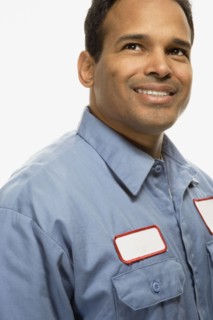 Studio shot of Hispanic maintenance man smiling