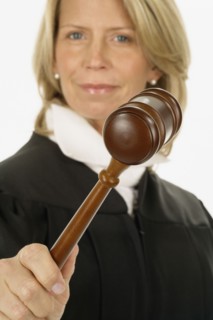 Studio shot of female judge holding gavel