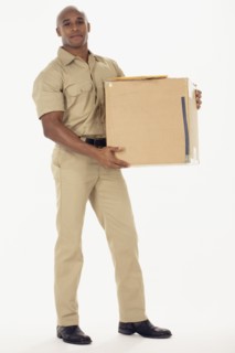 Studio shot of African delivery man with package